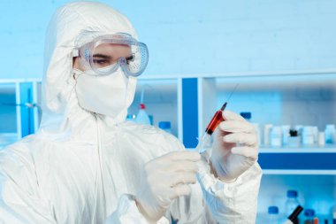 scientist in latex gloves holding syringe with vaccine  clipart