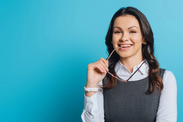Happy Businesswoman Smiling Camera While Holding Eyeglasses Blue Background — Stock Photo, Image