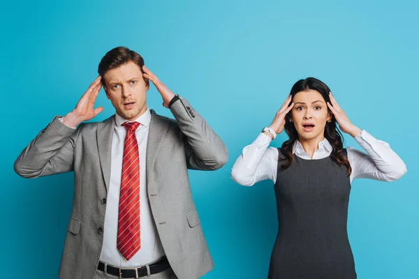 Two Exhausted Businesspeople Touching Heads While Suffering Migraine Blue Background — Stock Photo, Image