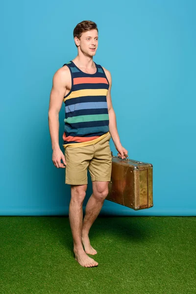 Handsome Man Striped Singlet Shorts Holding Vintage Suitcase Blue Background — Stock Photo, Image