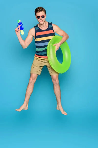 Young Man Sunglasses Holding Inflatable Ring Water Gun Blue Background — Stock Photo, Image