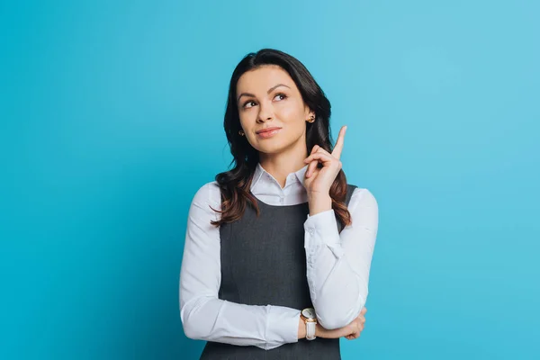 Dreamy Businesswoman Looking While Showing Idea Gesture Blue Background — Stock Photo, Image