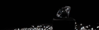 Panoramic shot of diamond near gemstones isolated on black  clipart