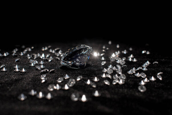 Selective focus of gemstones on black velvet isolated on black 