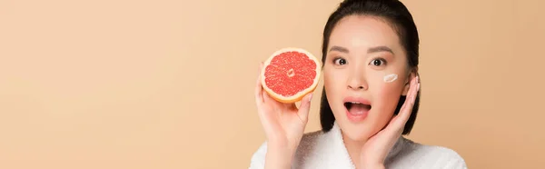 Shocked Beautiful Asian Woman Bathrobe Face Cream Cheek Grapefruit Half — Stock Photo, Image