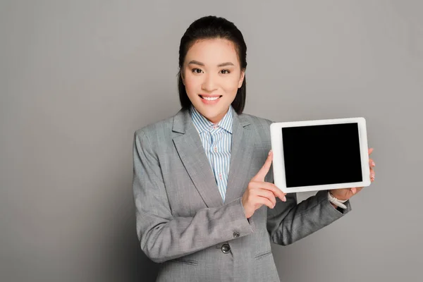 Happy Young Businesswoman Suit Holding Digital Tablet Grey Background — Stock Photo, Image