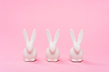 Pembe arka planda dekoratif paskalya tavşanları