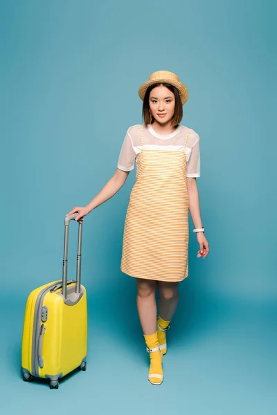 Asian Girl Striped Yellow Dress Straw Hat Suitcase Blue Background — Stock Photo, Image