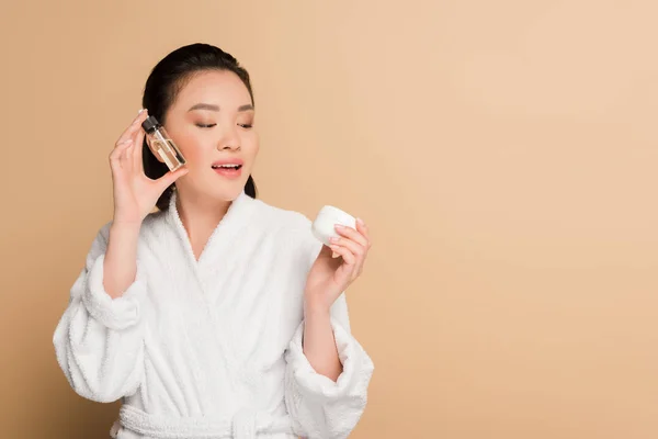 Smiling Beautiful Asian Woman Bathrobe Holding Cosmetic Cream Oil Beige — Stock Photo, Image