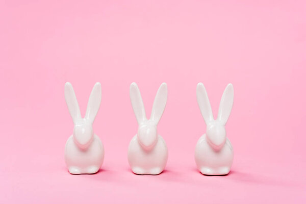 Decorative easter bunnies on pink background