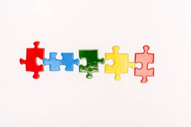 Top view of bright pieces of puzzle isolated on white, autism concept clipart