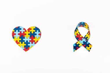 Top view of puzzle heart and awareness ribbon isolated on white, autism concept clipart