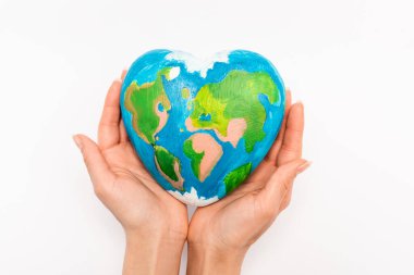Cropped view of globe in female hands on white background, earth day concept clipart
