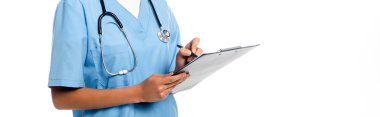 Cropped view of african american nurse with stethoscope writing on clipboard isolated on white, panoramic shot clipart