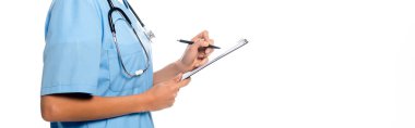 Cropped view of african american nurse writing on clipboard and smiling isolated on white, panoramic shot clipart