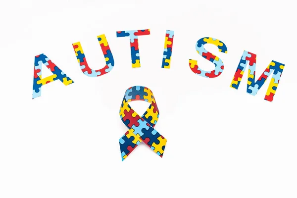 High Angle View Autism Puzzle Lettering Awareness Ribbon Isolated White — Stock Photo, Image