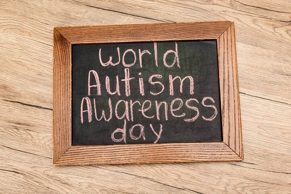 Top View Board World Autism Awareness Day Lettering Wooden Background — Stock Photo, Image