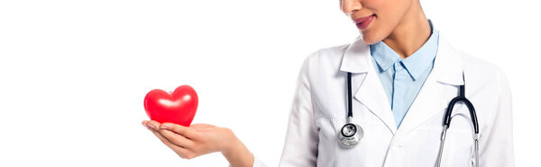 Cropped view of african american doctor showing decorative heart isolated on white, panoramic shot