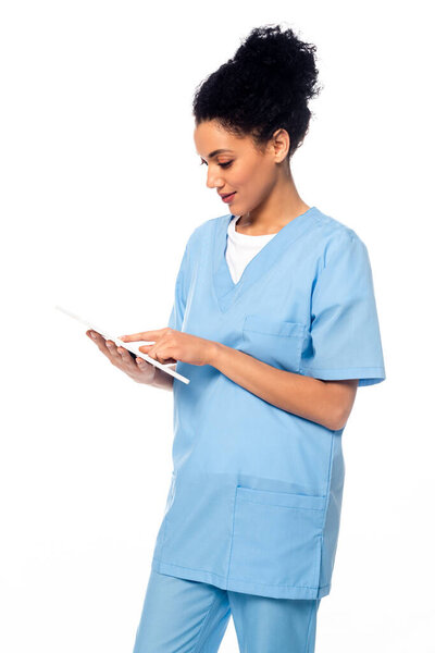 African american nurse using digital tablet isolated on white