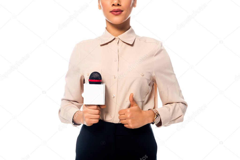 Partial view of african american journalist with thumb up holding microphone isolated on white