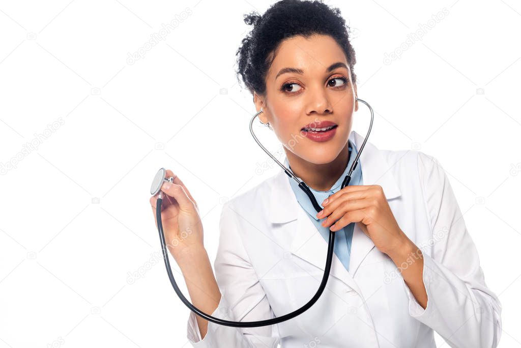 African american doctor listening with stethoscope isolated on white