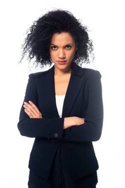 Kızgın Afro-Amerikalı iş kadınının kollarını kavuşturup beyaz kameraya bakması ön planda.