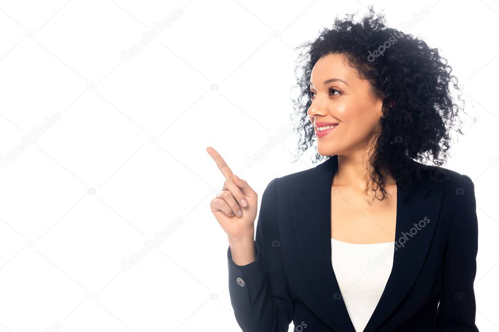 Beautiful african american businesswoman smiling and pointing aside isolated on white