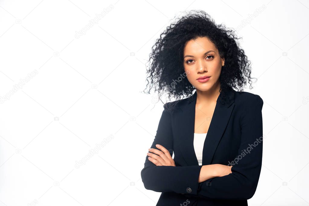 Front view of african american businesswoman with crossed arms looking at camera isolated on white