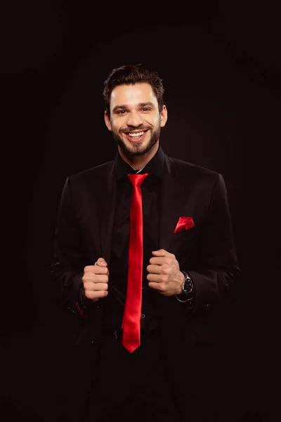 Handsome Man Black Suit Red Tie Smiling Camera Isolated Black — Stock Photo, Image