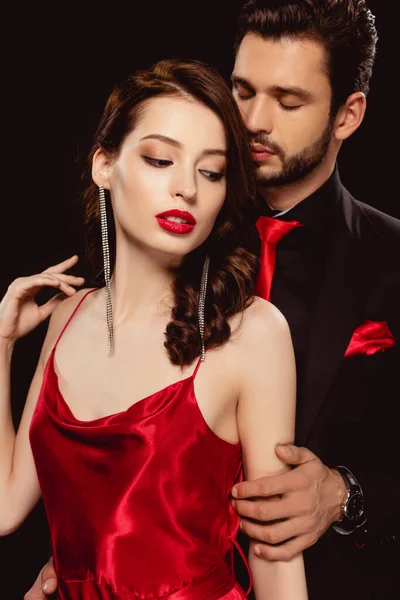 Elegante Hombre Abrazando Hermosa Mujer Vestido Rojo Aislado Negro — Foto de Stock