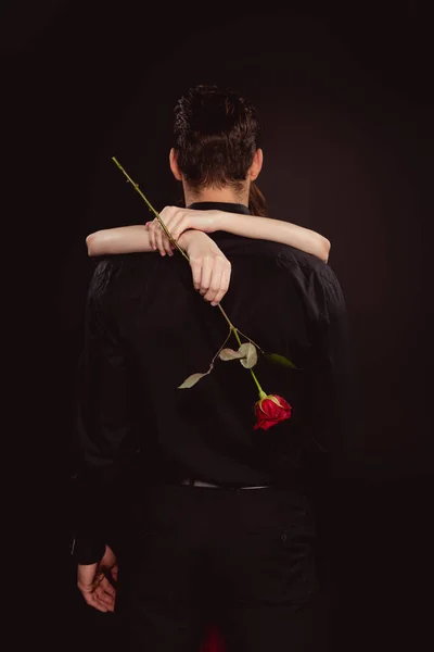 Back View Woman Holding Rose Hugging Boyfriend Isolated Black — Stock Photo, Image