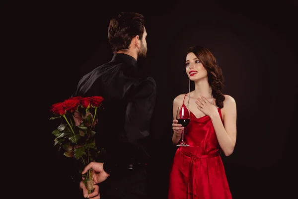 Elegant Man Hiding Bouquet Roses Smiling Girlfriend Red Wine Isolated — Stock Photo, Image