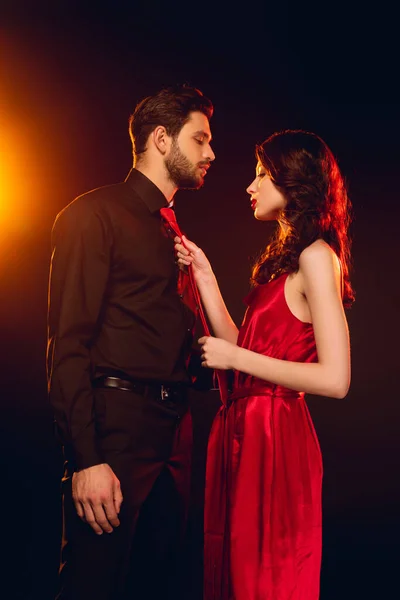 Side View Elegant Woman Holding Tie Boyfriend Black Background Lighting — Stock Photo, Image