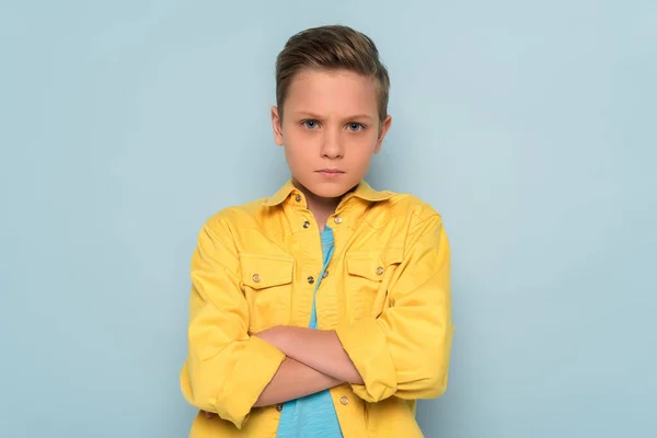 Offended Kid Crossed Arms Looking Camera Blue Background — Stock Photo, Image