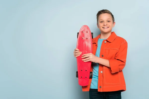 Smiling Kid Holding Penny Board Looking Camera Blue Background — Stock Photo, Image