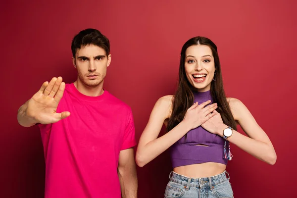 Serious Boyfriend Showing Stop Sign While Standing Excited Girlfriend Red — Stock Photo, Image