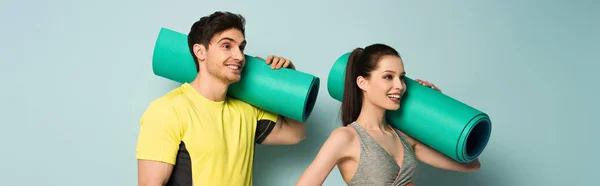 Panoramic Shot Smiling Athletic Couple Holding Fitness Mats Blue — Stock Photo, Image