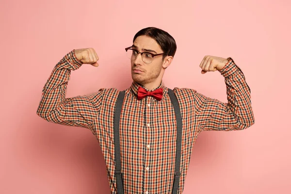Thoughtful Male Nerd Eyeglasses Showing Muscles Pink — Stock Photo, Image