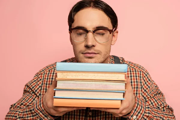 Male Nerd Eyeglasses Closed Eyes Holding Books Isolated Pink — Stock Photo, Image