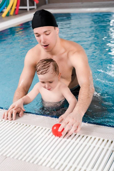 Handsome Swim Coach Swimming Cap Touching Ball Cute Toddler Boy — Stock Photo, Image