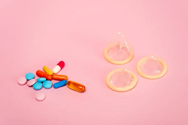 Close View Condoms Birth Control Pills Pink Background — Stock Photo, Image