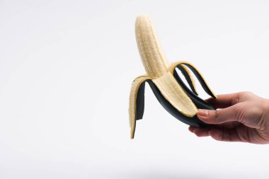 cropped view of woman holding ripe banana on white clipart