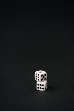 white and small dice on black with copy space  clipart