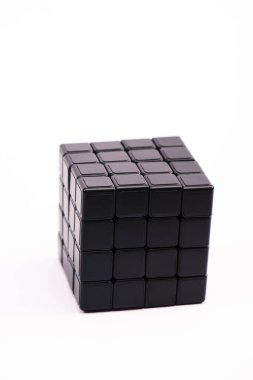 KYIV, UKRAINE - FEBRUARY 21, 2020: selective focus of black rubik cube isolated on white  clipart