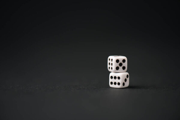 white dice on black with copy space 