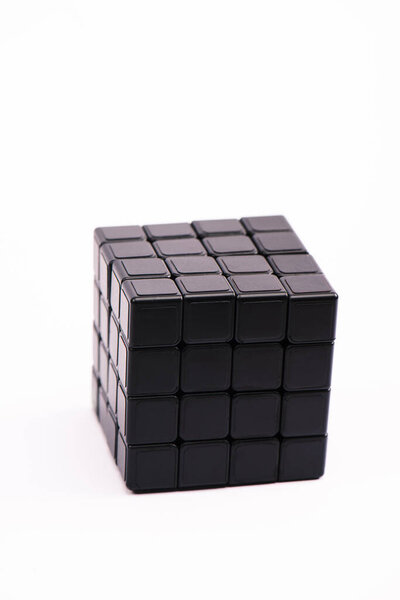 KYIV, UKRAINE - FEBRUARY 21, 2020: selective focus of black rubik cube isolated on white 