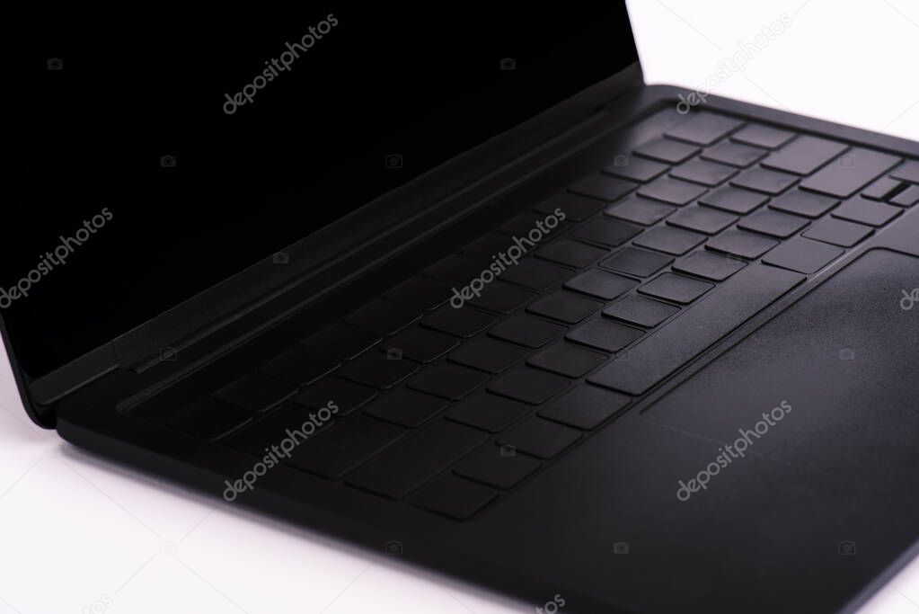 modern and black laptop with blank screen on white 