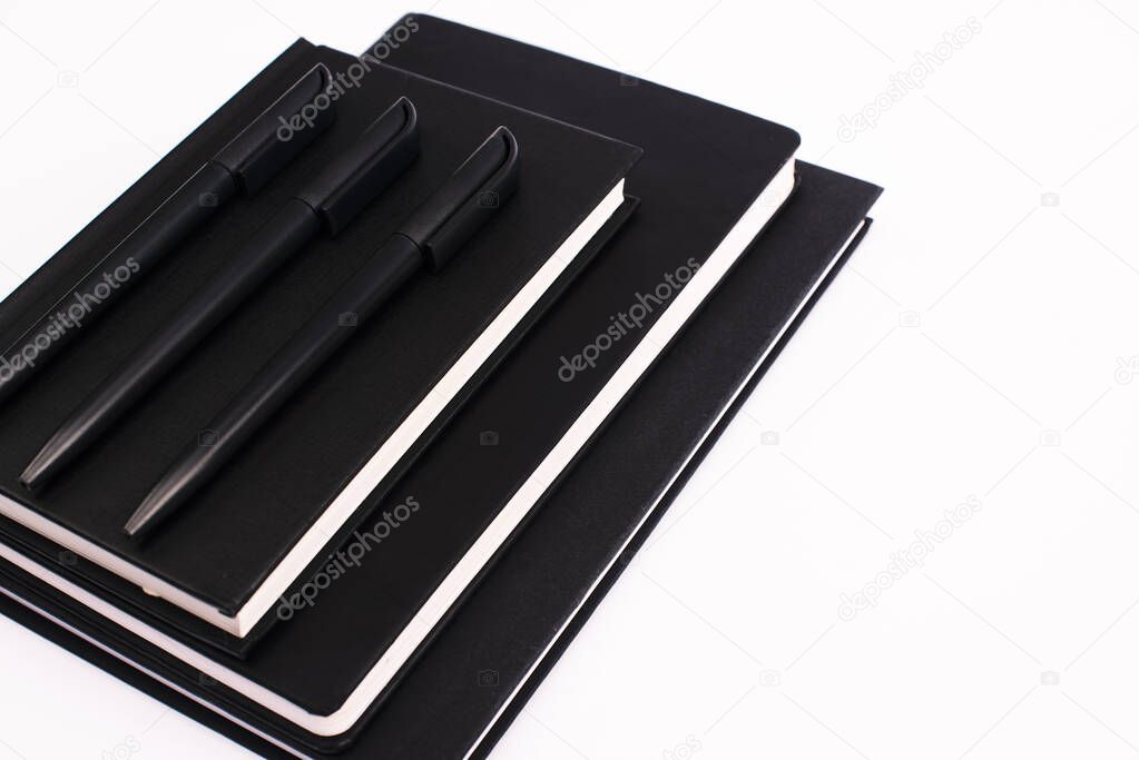 black pens on copy books isolated on white with copy space 