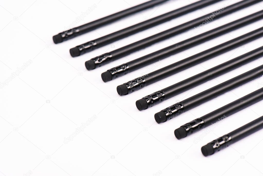 selective focus of black pencils with erasers isolated on white 