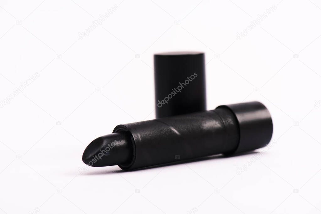 selective focus of black lipstick on white with copy space